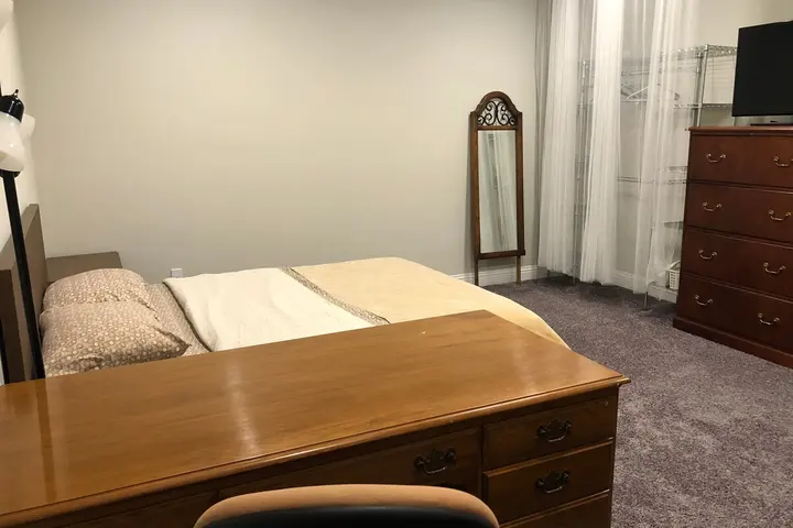Queen bed with desk and mirror