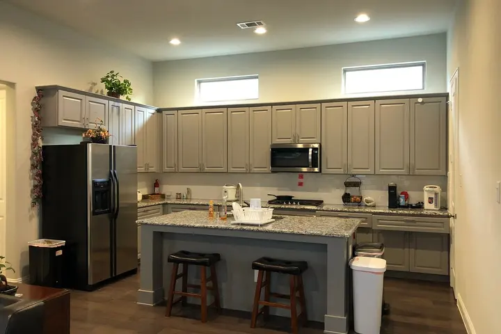 Kitchen with granite island and stainless appliances