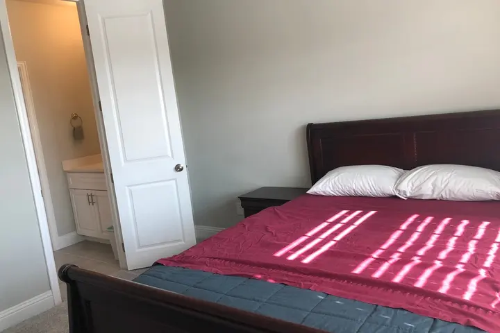 Queen bed with closet beyond