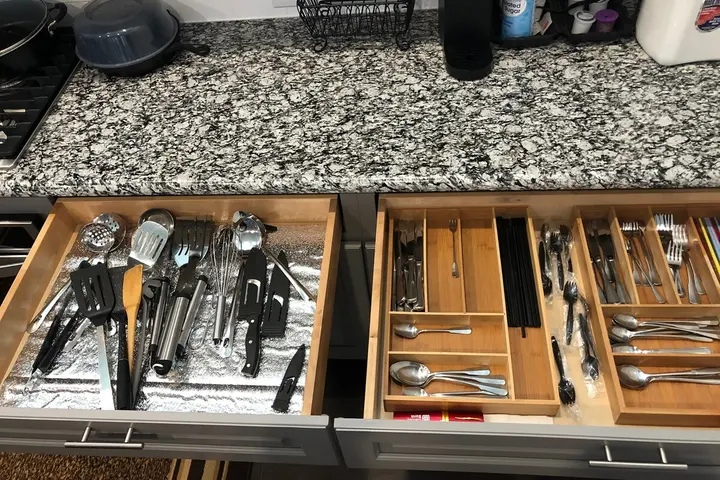 Drawers stocked with cooking utensils and flatware