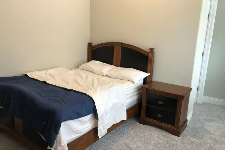Bed with nightstand and window