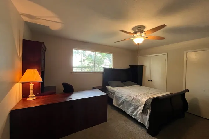 Queen bed with bedside lamp