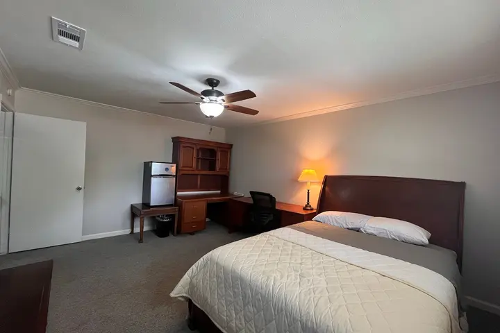 Queen bed with warm lamplight