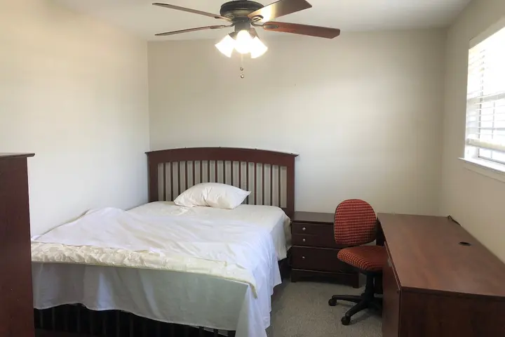 Bed and desk beside a window