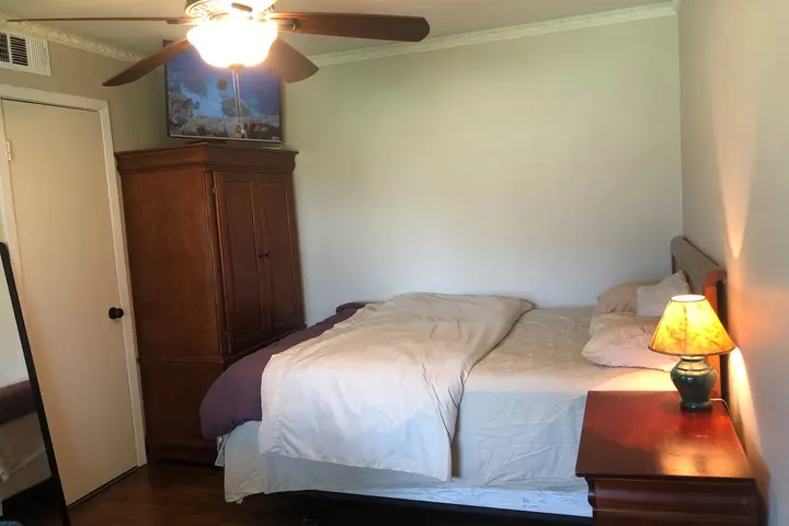 Queen bed with warm bedside lighting