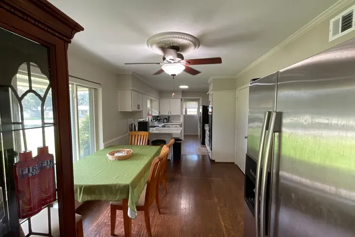Dining area with a large table and hardwood floors