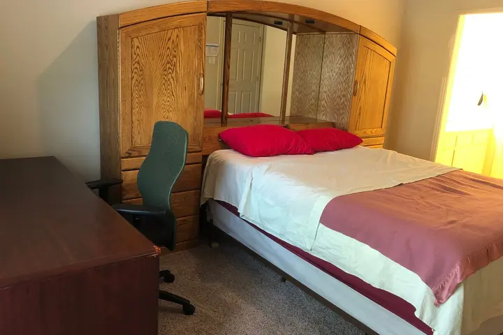 Queen bed with desk and office chair